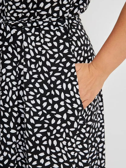 Close-up of the Monaco Midi Dress showcasing a black and white print with a side pocket, highlighting comfort and style.
