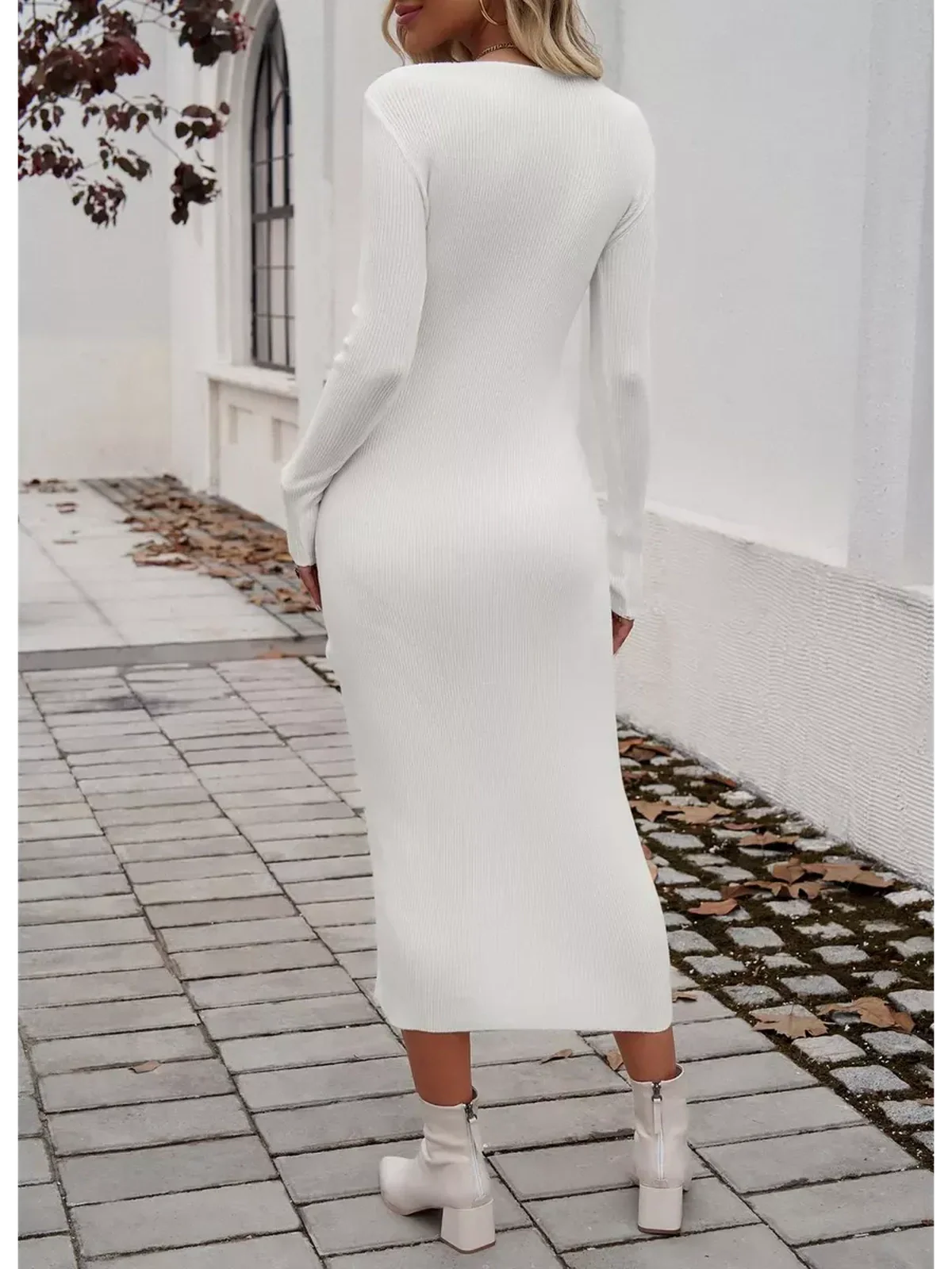 Back view of a woman wearing a sleek white Sculpted Charm Midi Dress with long sleeves and a ribbed texture.