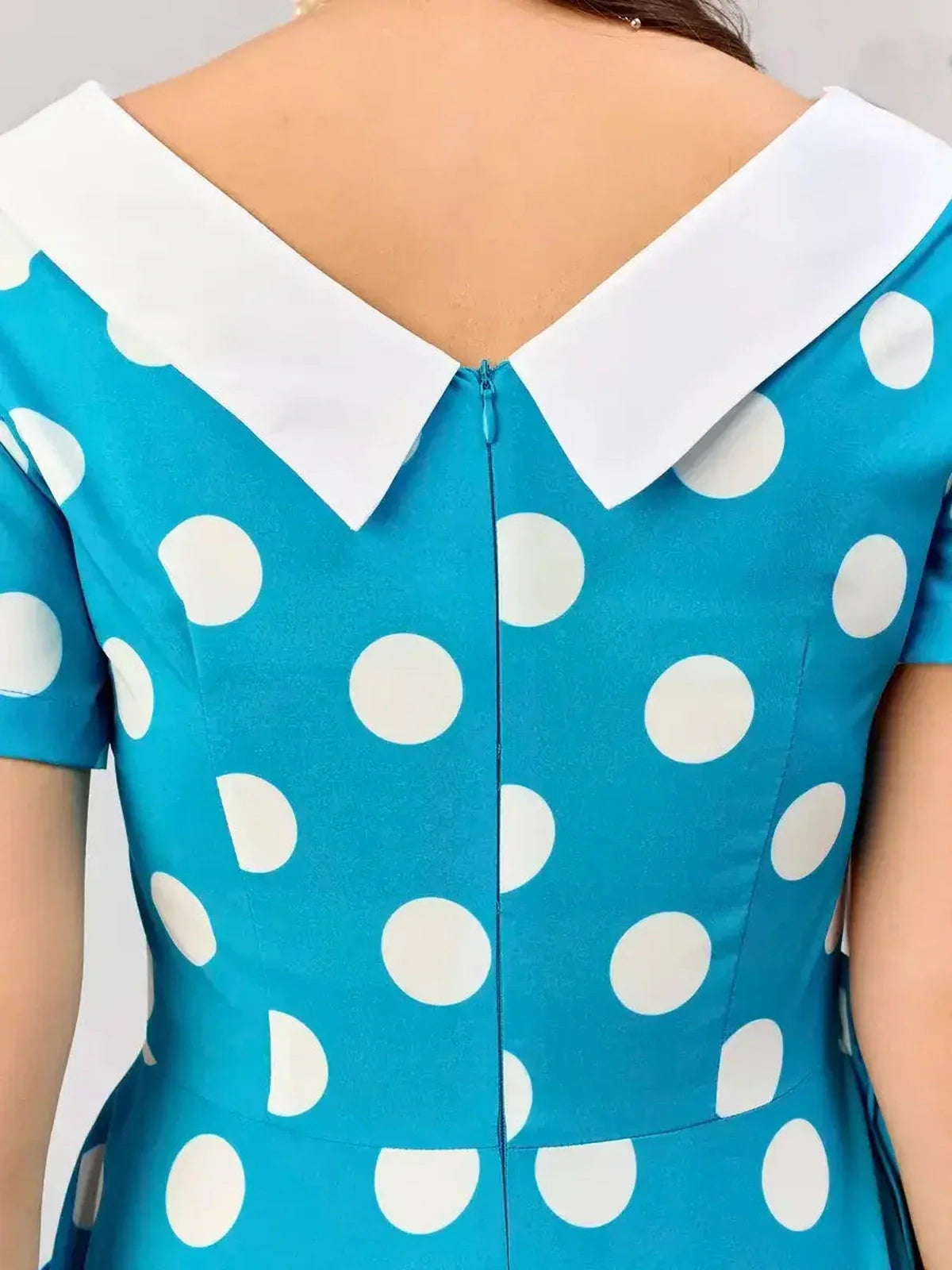 Back view of Retro Charm Midi Dress featuring bold polka dots and a classic white contrast collar, ideal for stylish occasions.