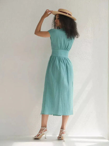 Elegant woman in a sea-green Veranda Midi Dress, showcasing a flattering corset waist and breezy silhouette.