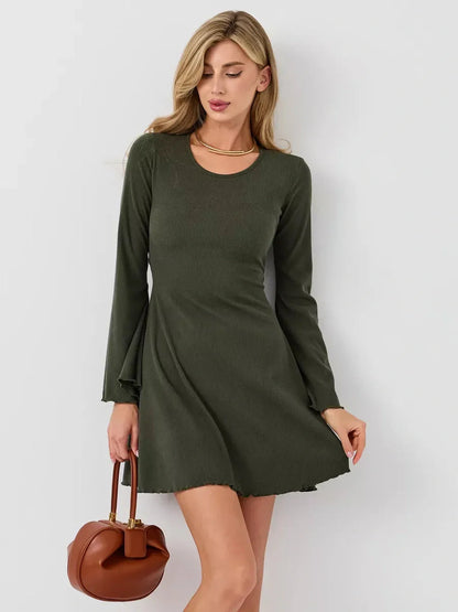 Model wearing the Ivy Bell mini dress in olive green with flared sleeves, perfect for summer outings or casual events.