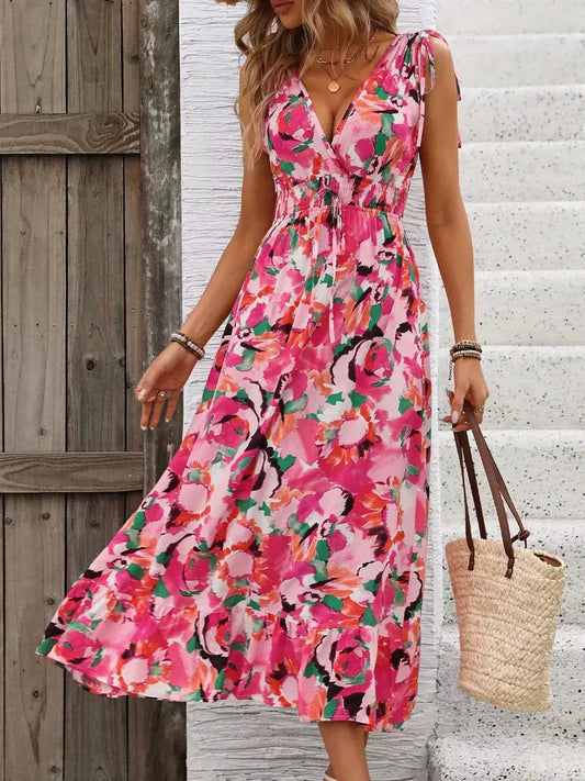 Vibrant floral midi dress in pink tones, perfect for summer events and casual outings.