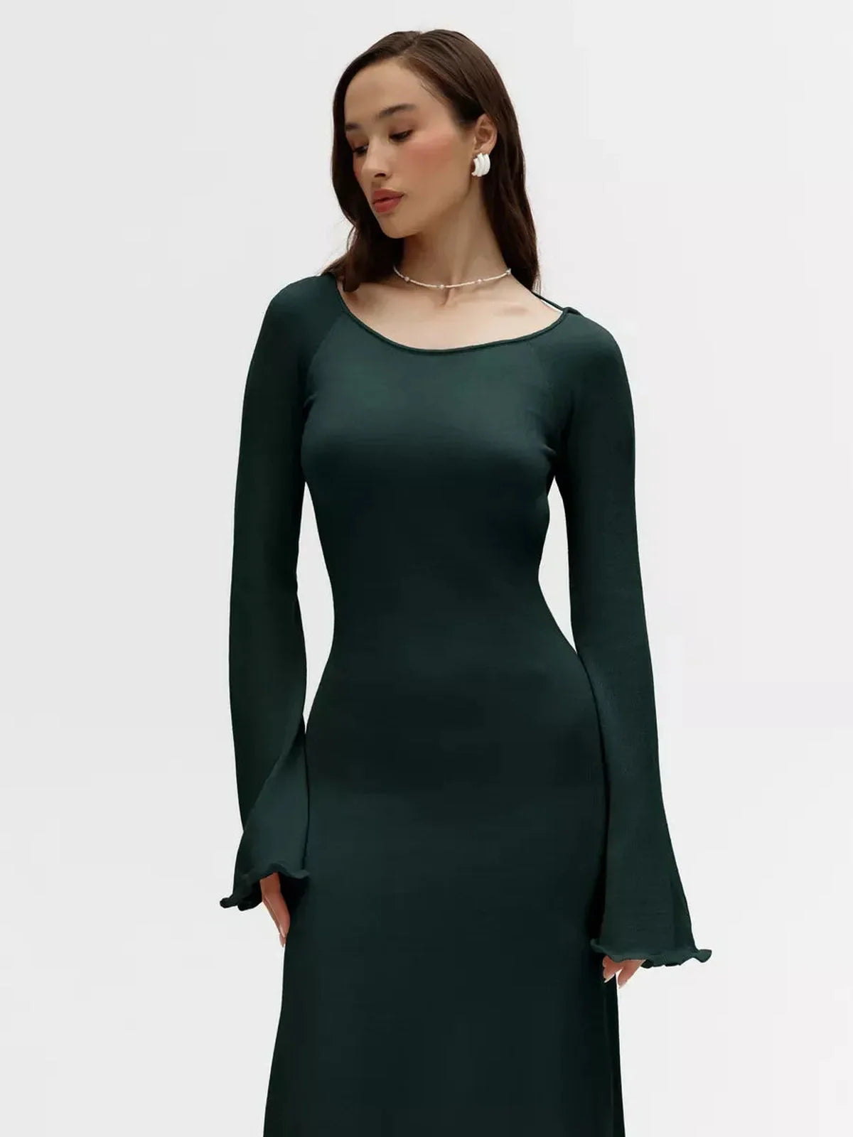 Serenity Knit Midi Dress in dark green with flounced sleeves and a fitted silhouette, perfect for formal and casual occasions.