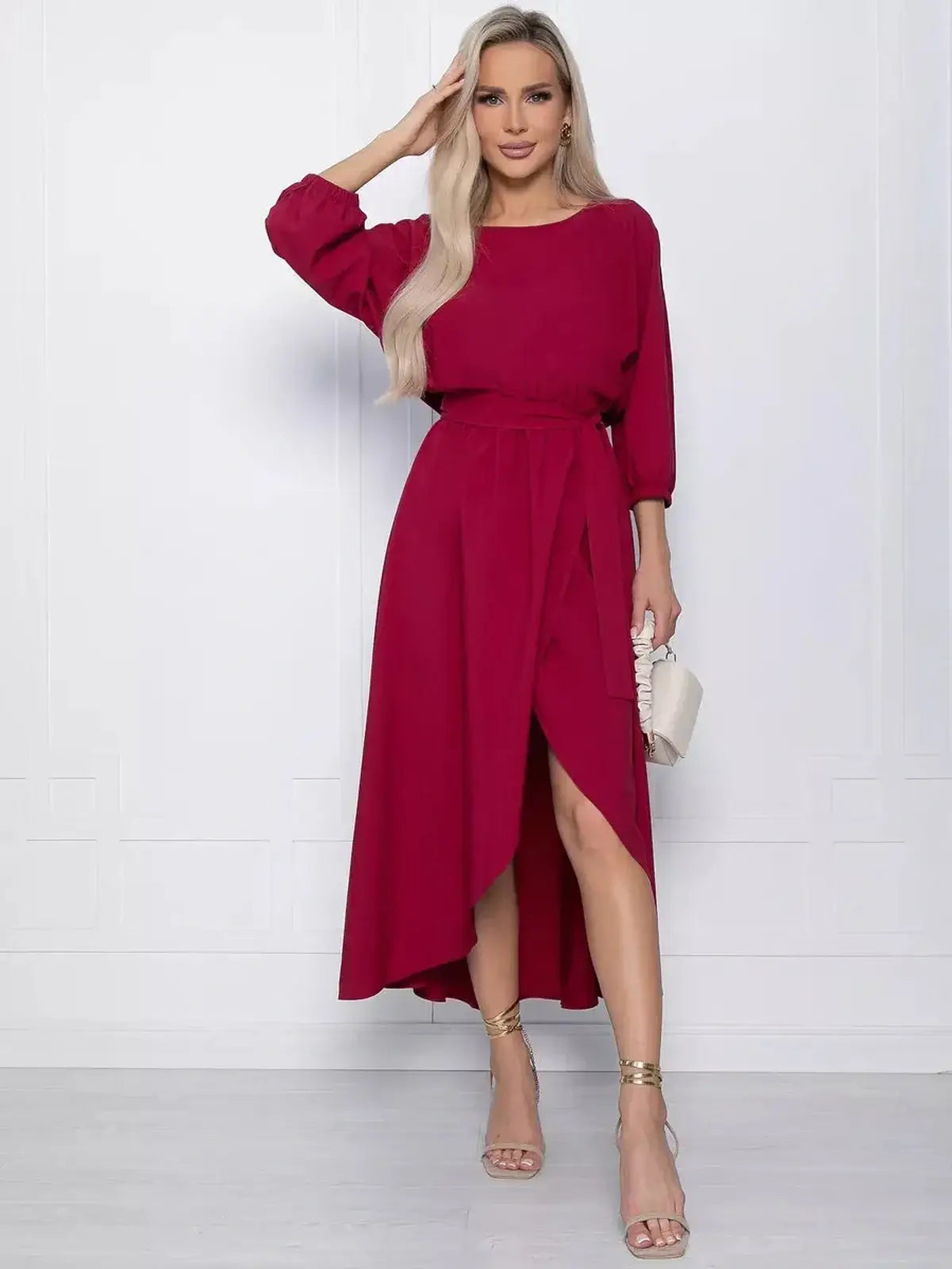 Elegant crimson midi dress with high-low hem and dramatic slit, perfect for weddings and special occasions.
