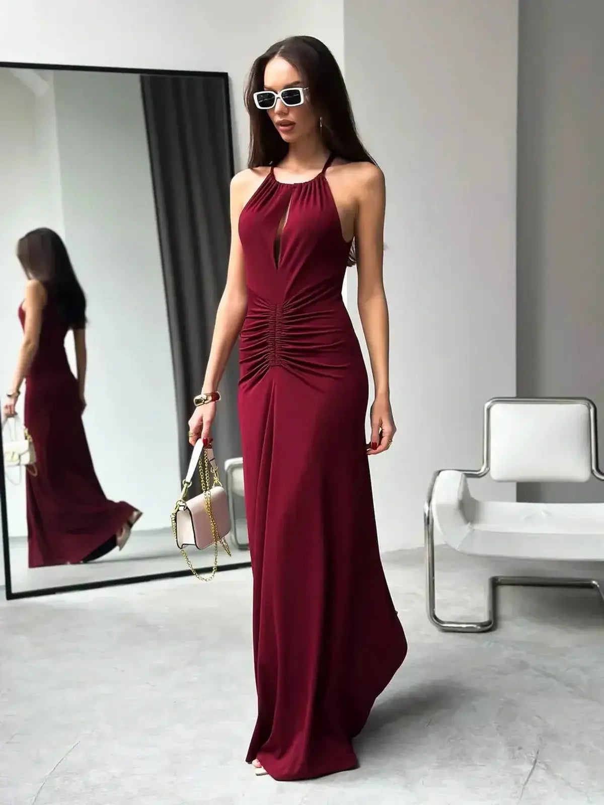 Chic Maxi Dress Élan in burgundy featuring a draped halter design and ruched waist, perfect for evening events and summer occasions.