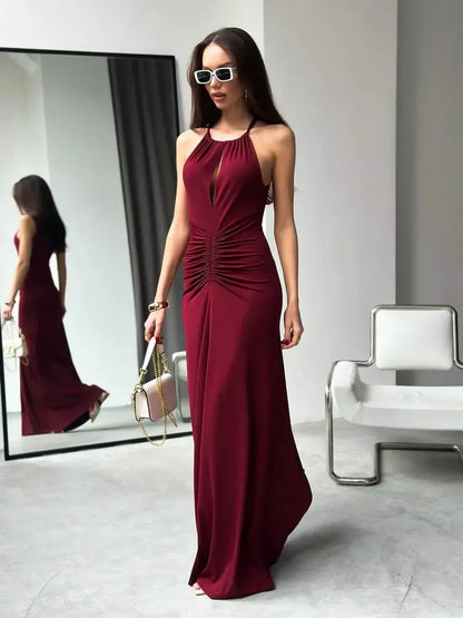 Chic Maxi Dress Élan in burgundy featuring a draped halter design and ruched waist, perfect for evening events and summer occasions.