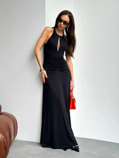 Elegant black maxi dress with ruched halter design, ideal for formal events and summer soirées.