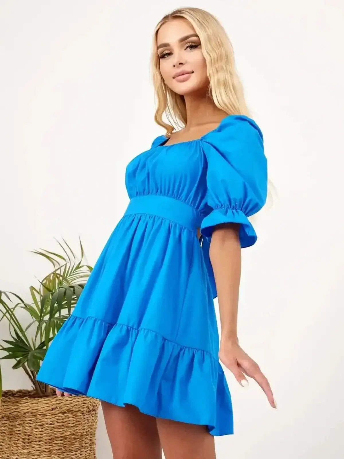 Vibrant blue mini dress with A-line silhouette and tiered skirt, perfect for summer weddings and casual outings.