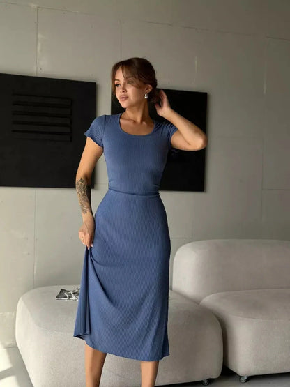 Sculpted Grace Midi Dress in blue, featuring a ribbed texture and corset tie back, perfect for summer events and formal occasions.