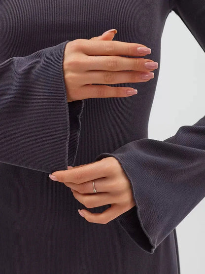 Close-up of flared sleeves on the Graphite Charm Mini Dress, showcasing the soft knit texture and elegant design.