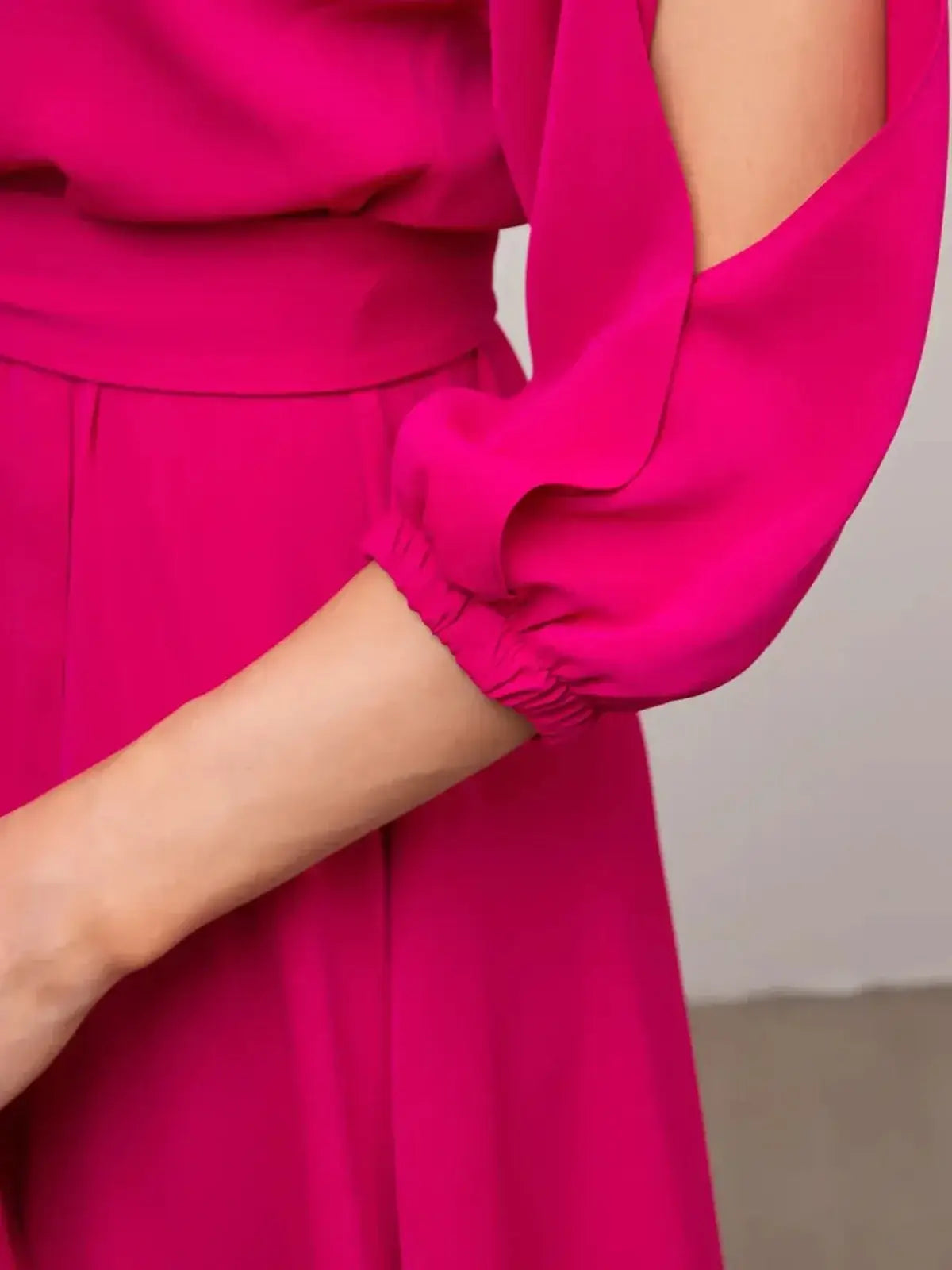 Close-up of the Twilight Bloom Midi Dress's shoulder cutouts and puff sleeve in radiant fuchsia.