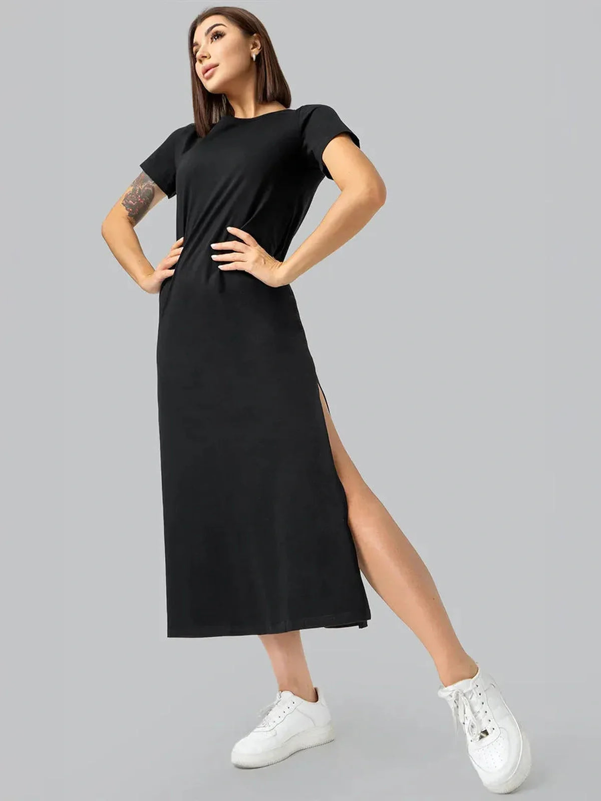 Stylish black midi dress with side slit, perfect for casual outings and elegant evenings.