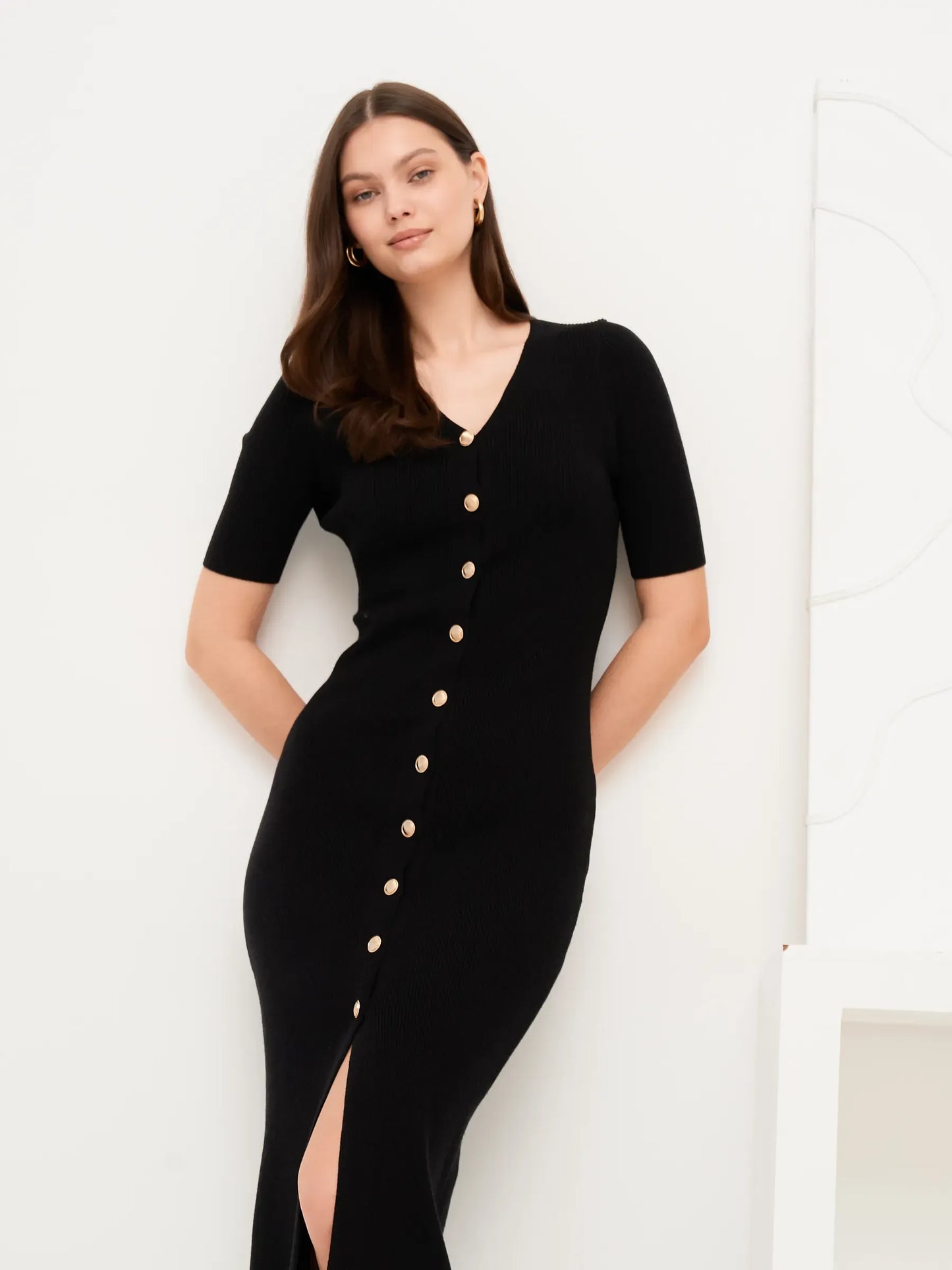 Elegant black midi dress with gold button detail and fitted rib knit, perfect for formal occasions and summer events.