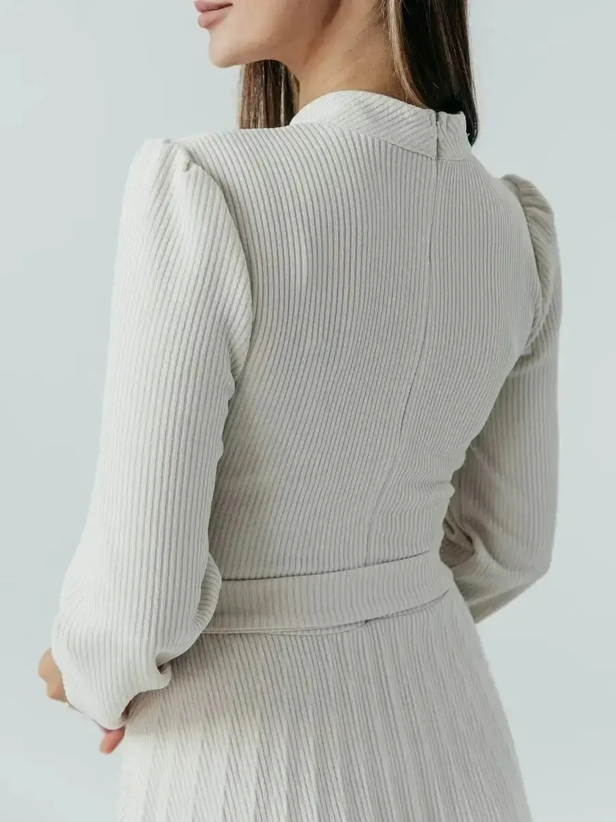 Close-up of the back of the Grace Pleat Midi Dress featuring ribbed knit and elegantly puffed sleeves.
