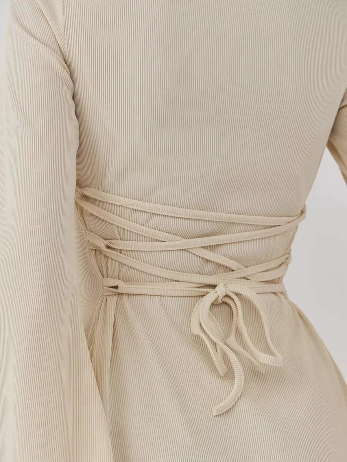 Detail of the back ties of the Sculpted Grace mini dress, showcasing a customized sculpted fit.