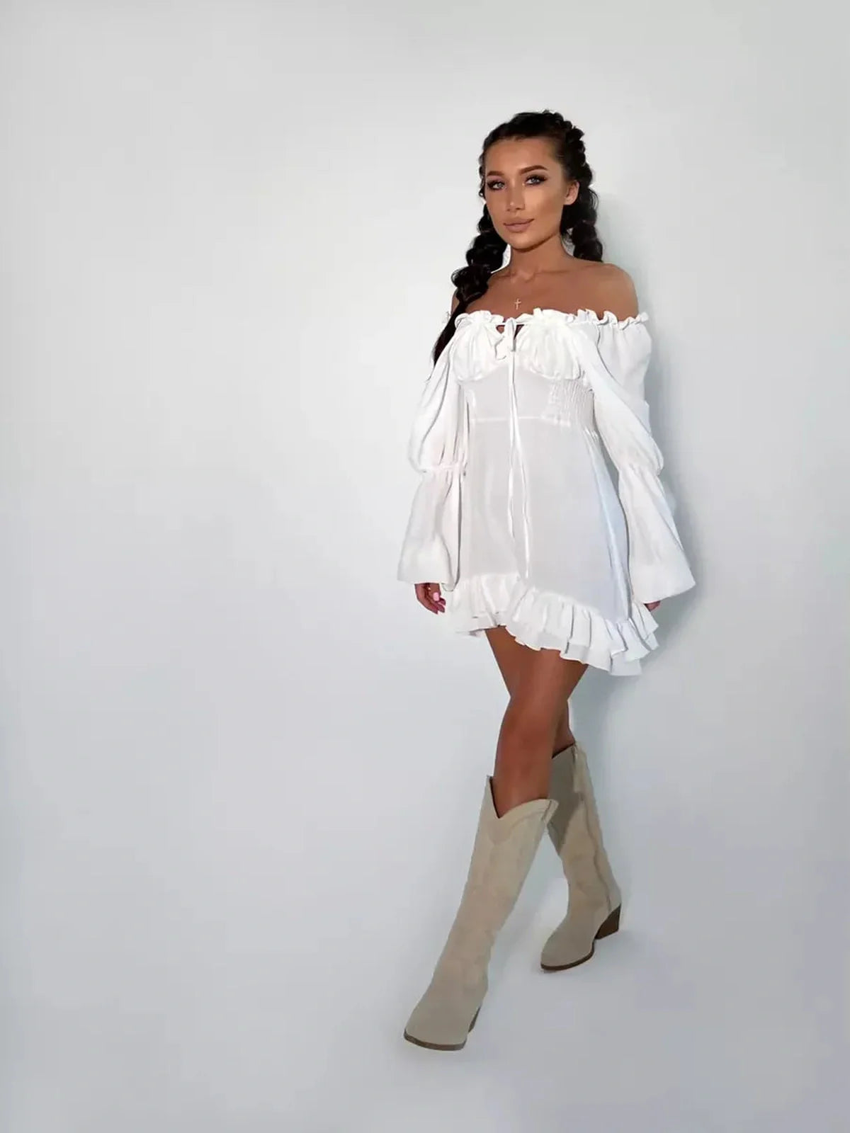 Elegant off-shoulder Ruffle Bloom Mini Dress in white, featuring voluminous sleeves and flirty ruffles, perfect for summer.