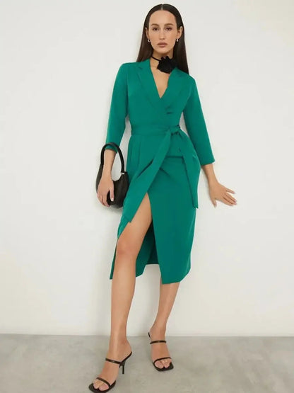 Emerald green Sculpted Grace midi dress with belted waist, sharp collar, and elegant wrap-style front for sophisticated occasions.