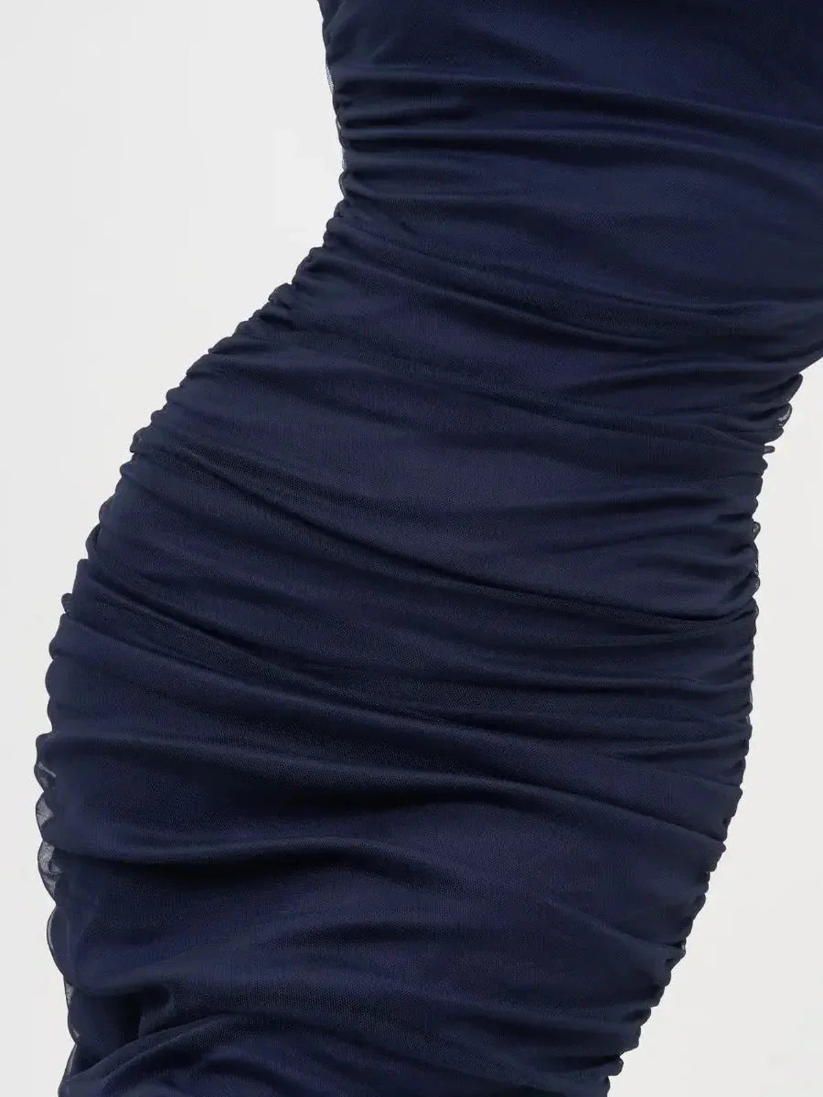 Close-up of Sculpted Mesh Midi Dress in navy blue showcasing mesmerizing ruching detail.