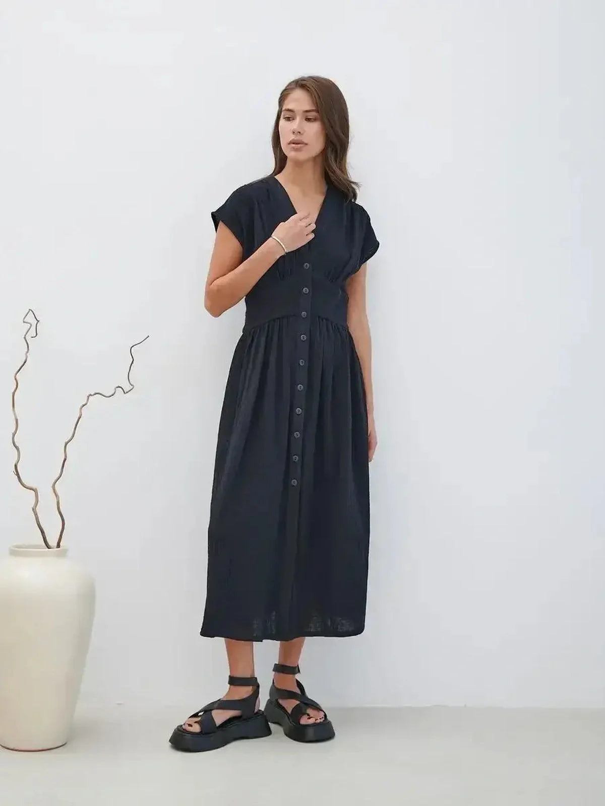 Sable Grace Midi Dress in black with a V-neck, button detail, and sculpted waist, perfect for summer and formal occasions.