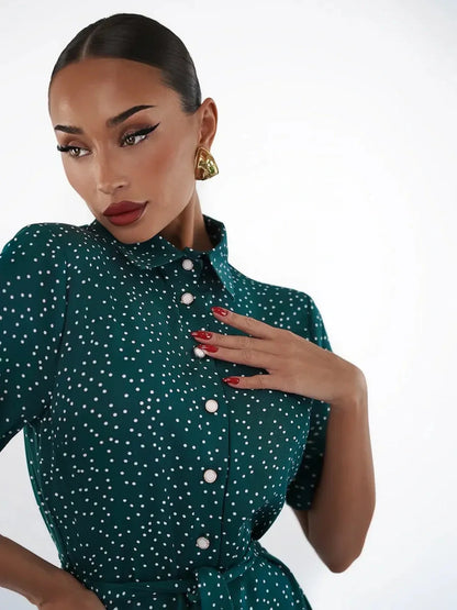 Elegant woman in an emerald dot midi dress, showcasing a sophisticated style with white polka dots and a button-down design.