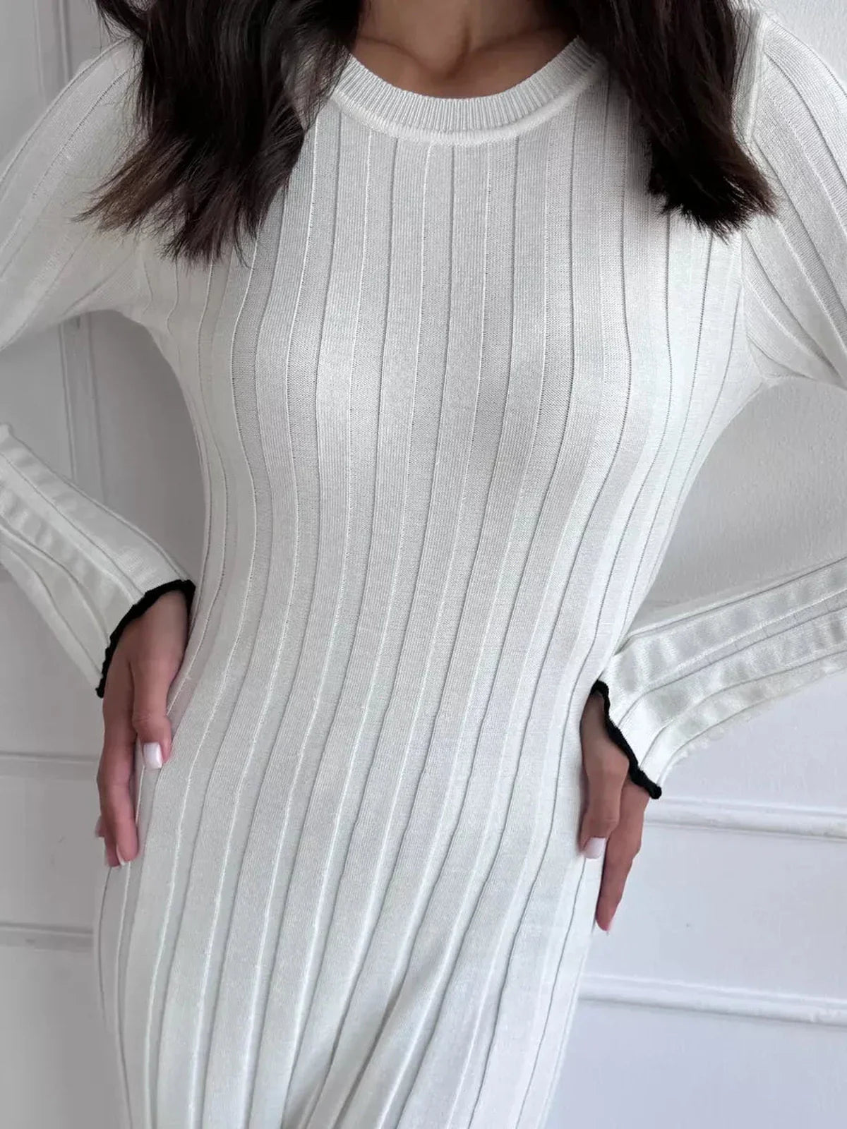 Close-up of women's Ivory Grace Maxi Dress featuring elegant ribbed texture and long sleeves.