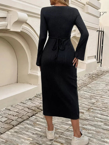 Back view of the Sculpted Chic Midi Dress in black, featuring ribbed knit, bell sleeves, and a drawstring waist.