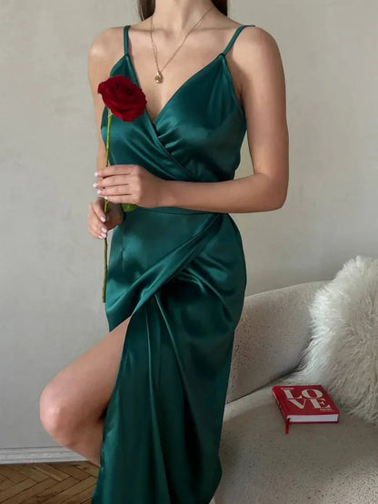 Model wearing an emerald satin wrap midi dress with a leg slit, holding a red rose, stylish and elegant for special occasions.
