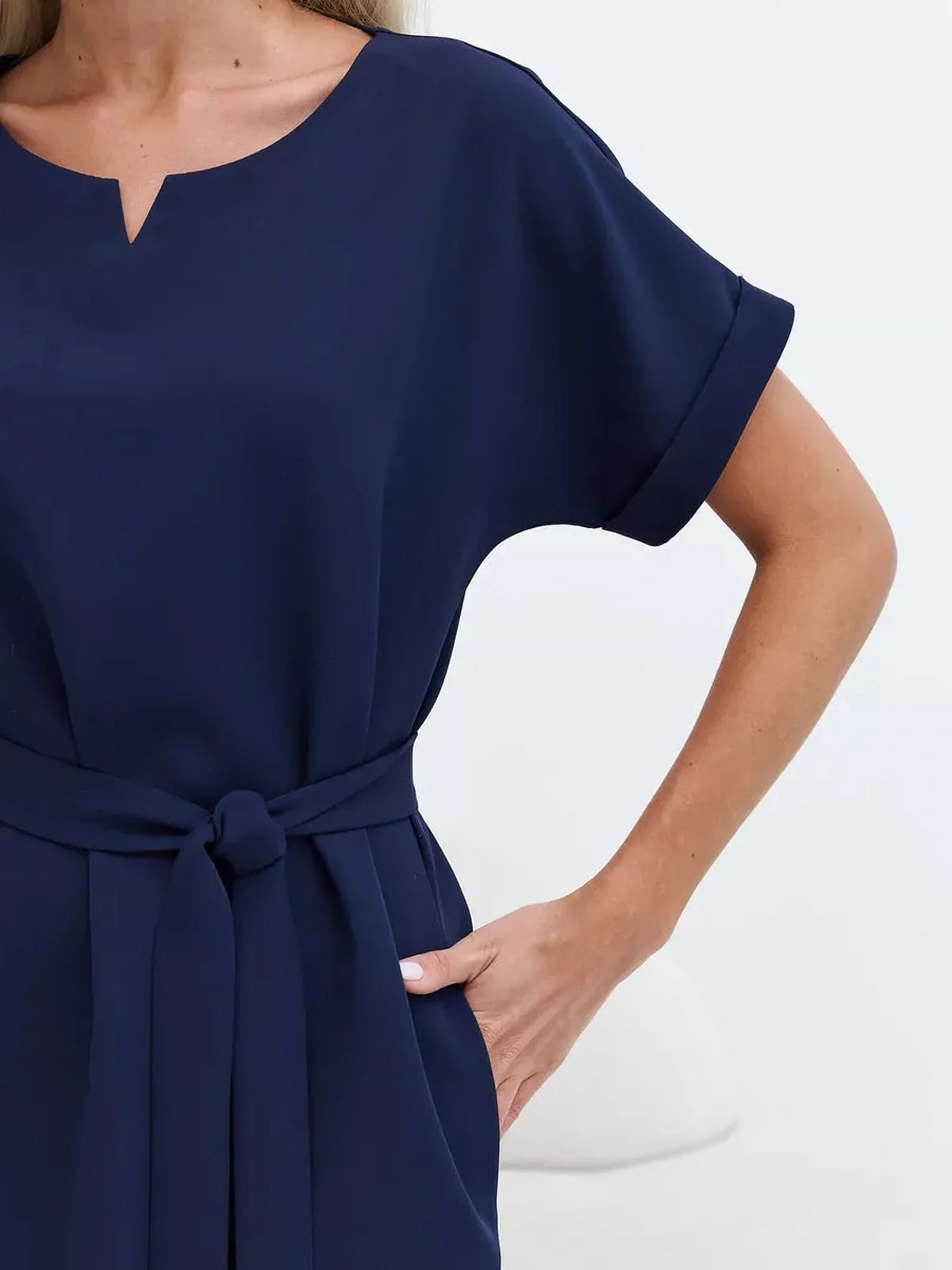 Close-up of a navy mini dress featuring a relaxed sheath cut and tied belt, perfect for summer and formal occasions.