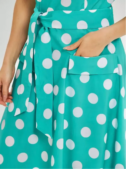 Polka Grace Midi Dress detail showcasing turquoise fabric with white polka dots, tie waist, and side pocket.
