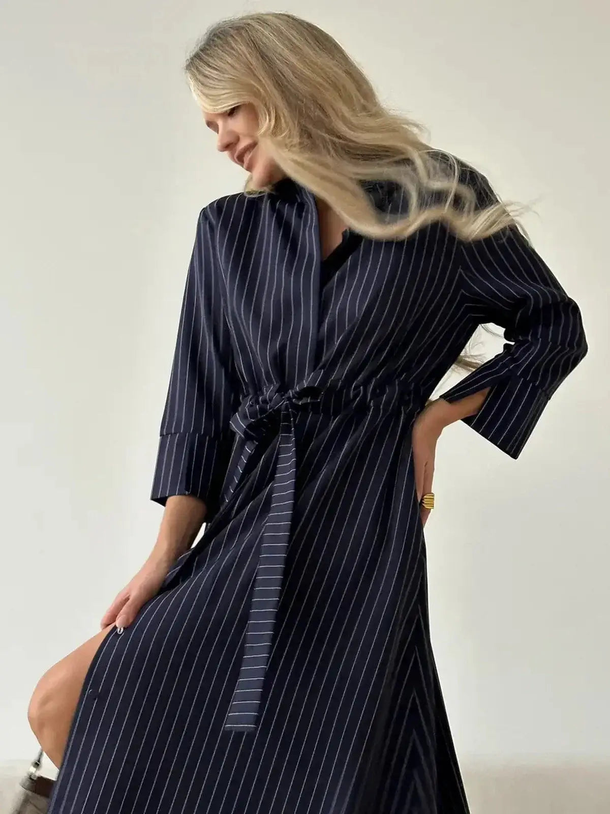 Pinstripe midi dress with self-tie waist, featuring an elegant collar and relaxed fit, perfect for summer and formal occasions.