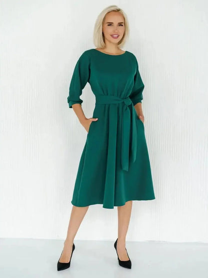 Emerald Aura Midi Dress with belted waist, elegant boat neckline, and A-line silhouette, ideal for weddings or formal events.