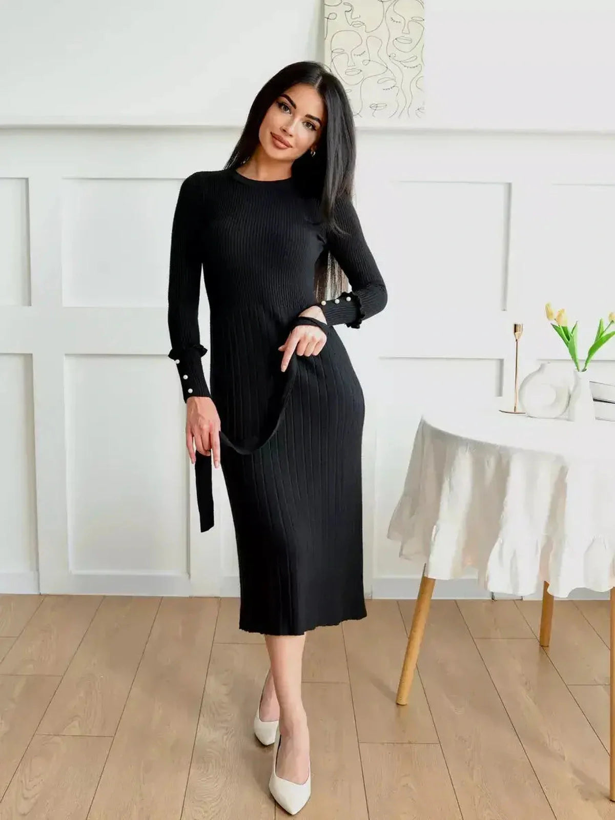 Elegant black midi dress with ribbed texture and pearl detail, perfect for weddings, parties, or casual outings.