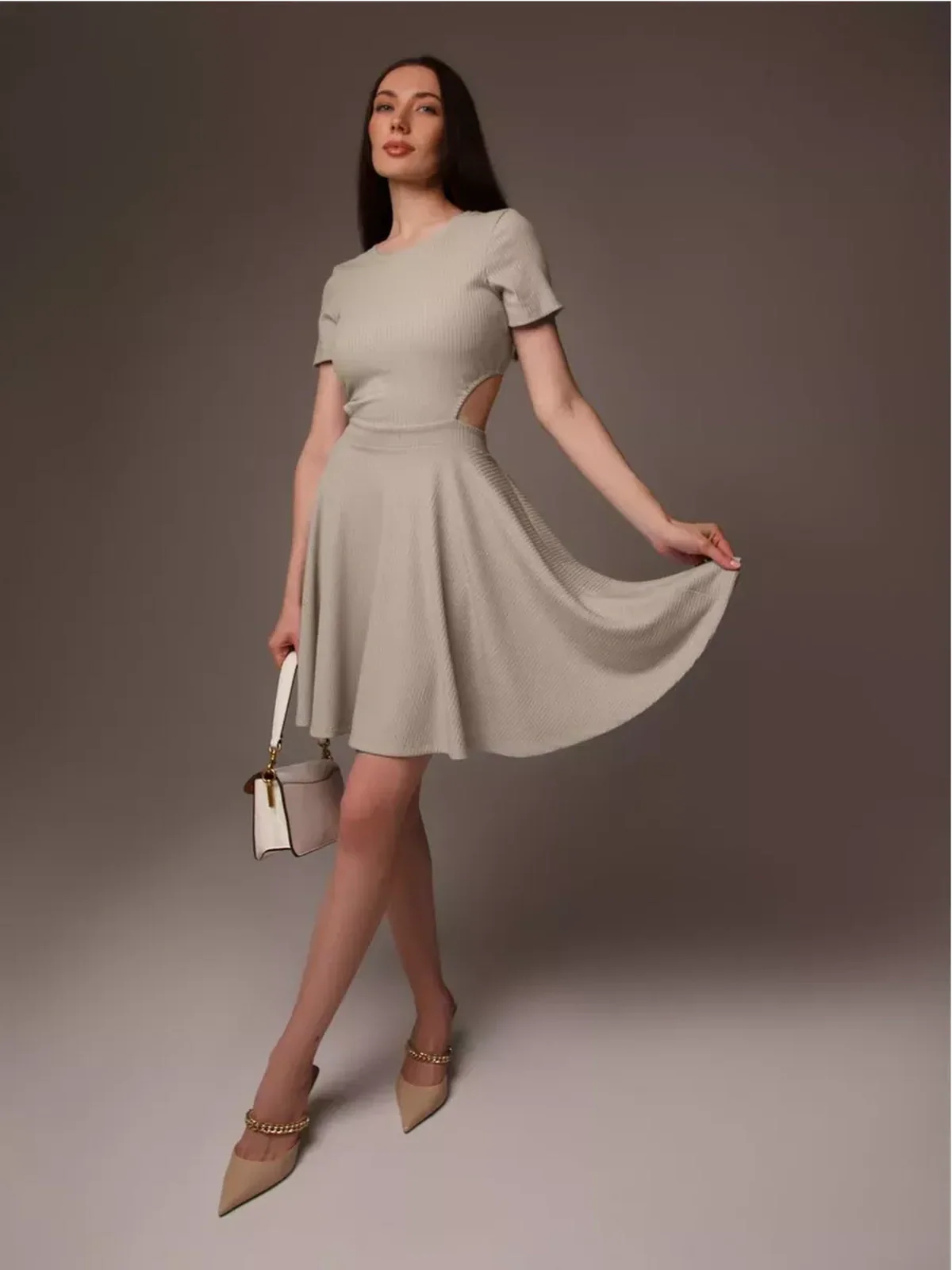 Model in a stylish Breezy Hour mini dress, a chic summer dress with a cutout detail and flared hem.