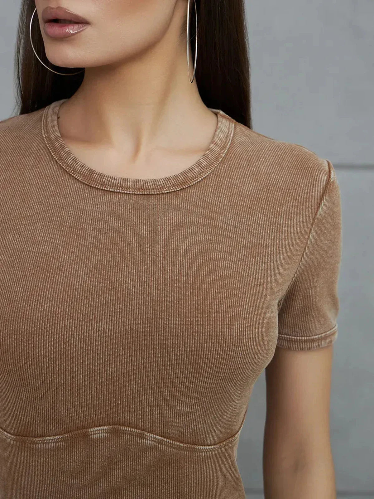 Close-up of a model wearing a Sculpted Ease Maxi Dress in washed tobacco hue, showcasing fabric texture and silhouette.