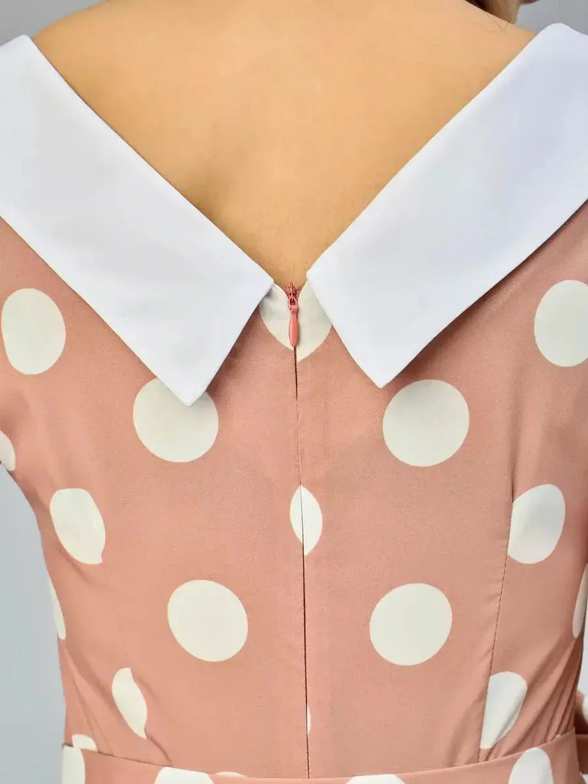 Back view of Vintage Muse Midi Dress featuring a polka dot design and a stylish white collar detail.