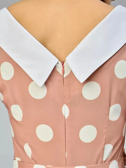Back view of Vintage Muse Midi Dress featuring a polka dot design and a stylish white collar detail.
