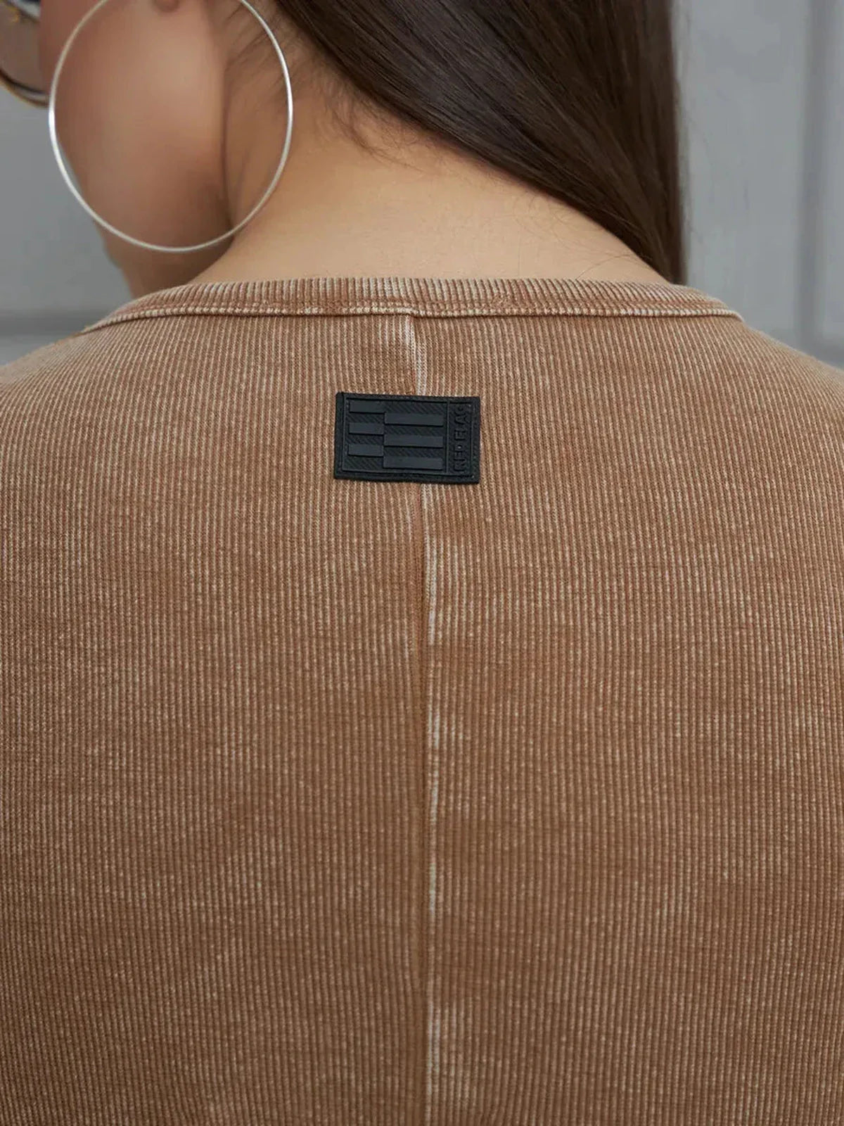 Close-up of the back neckline and label of a Sculpted Ease Maxi Dress in washed tobacco color.