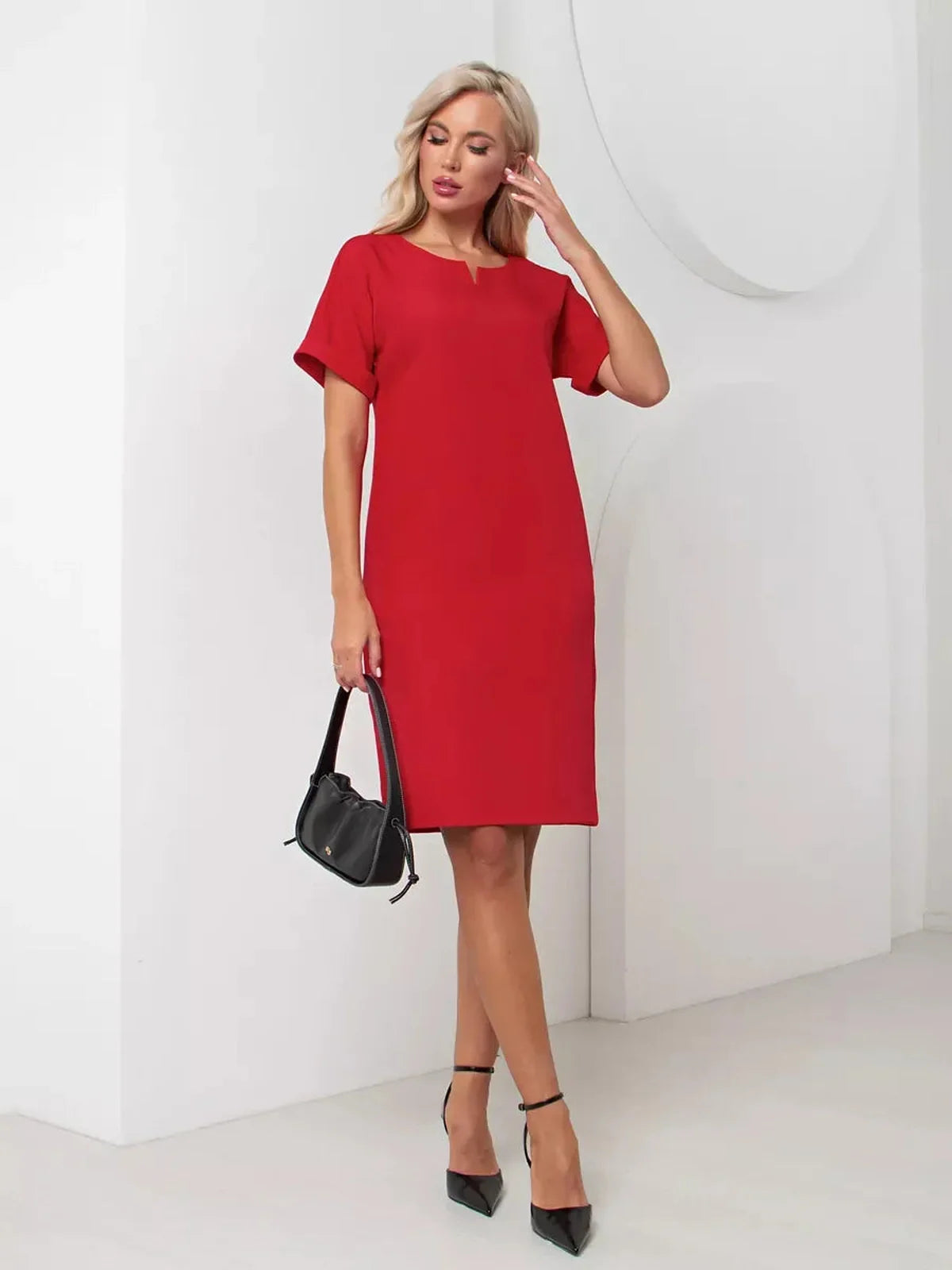 Stylish red mini dress with a clean neckline, perfect for summer weddings and cocktail events.