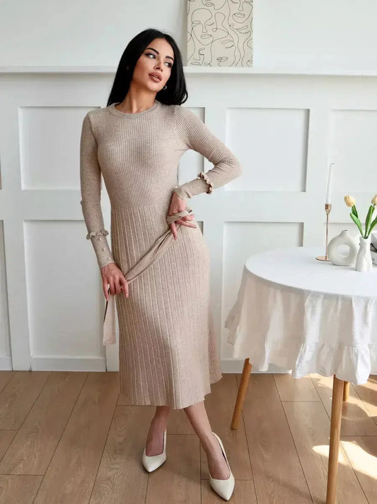 Model wearing a Serene Knit Midi Dress in beige, featuring ribbed texture and long sleeves, perfect for various occasions.