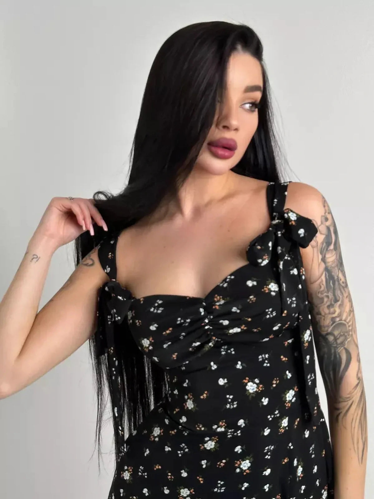Elysian Midi Dress in black floral with romantic bows, showcasing a sweetheart neckline and elegant summer style for women.