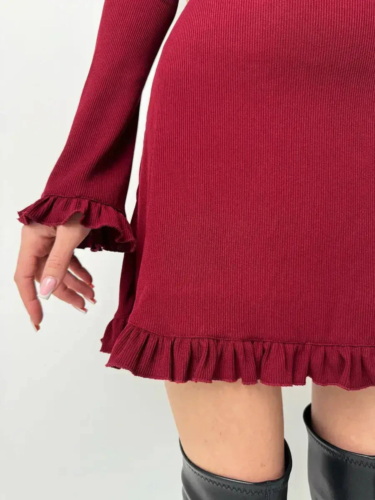 Close-up of the Crimson Flare red dress showcasing ruffle details at the hem and cuffs, perfect for fall and special occasions.