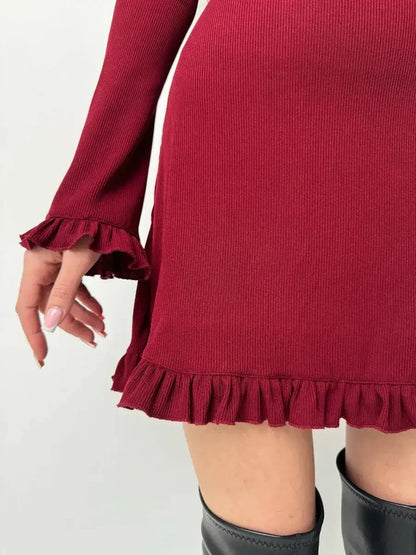 Close-up of the Crimson Flare red dress showcasing ruffle details at the hem and cuffs, perfect for fall and special occasions.