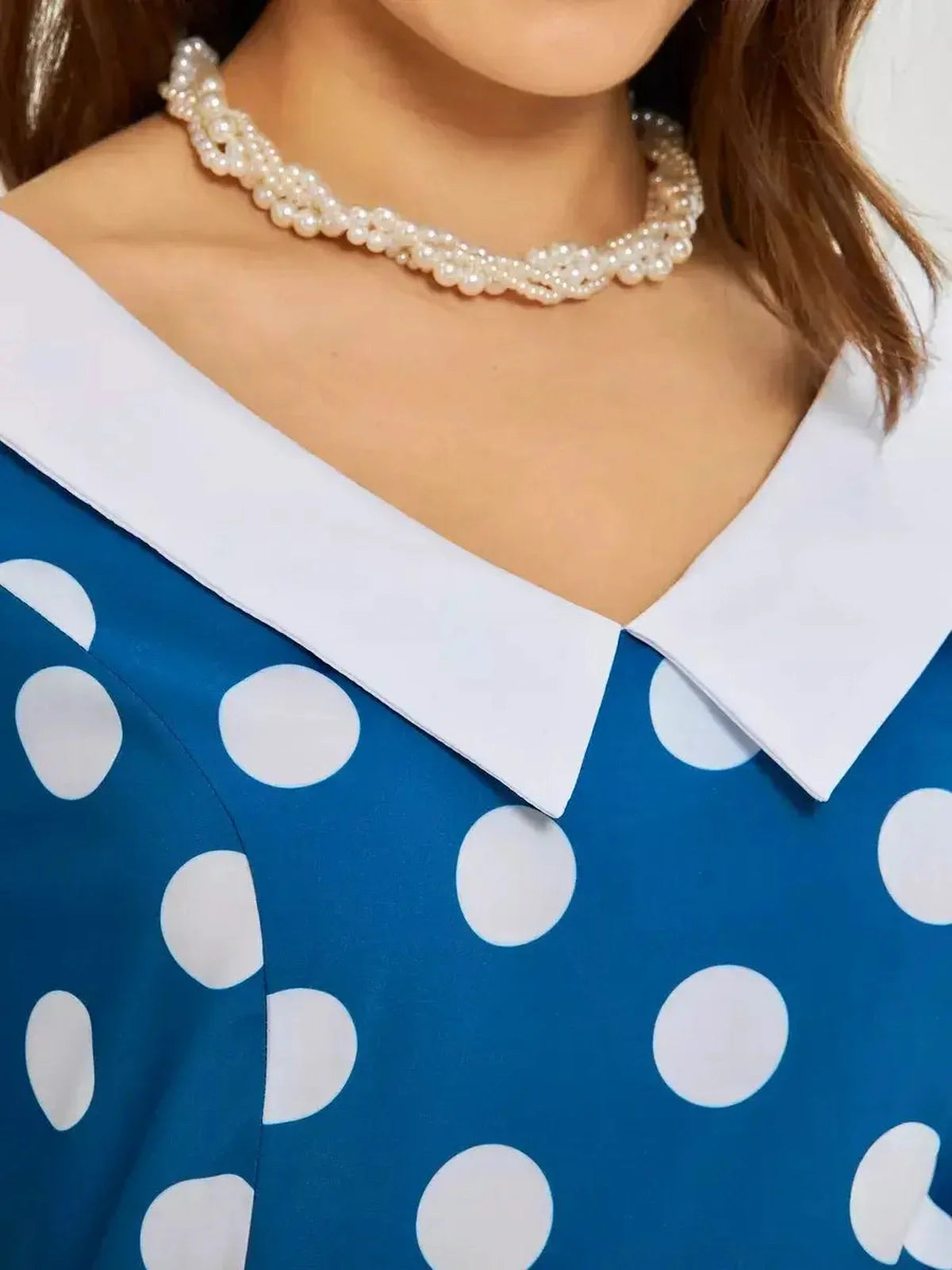 Close-up of the Pearl Dot Midi Dress featuring a white collar and oversized polka dots in dark teal.