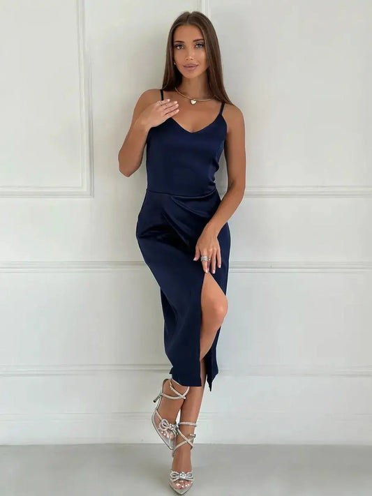 Model wearing a sleek navy satin midi dress with a V-neckline and slit, perfect for weddings or formal events.
