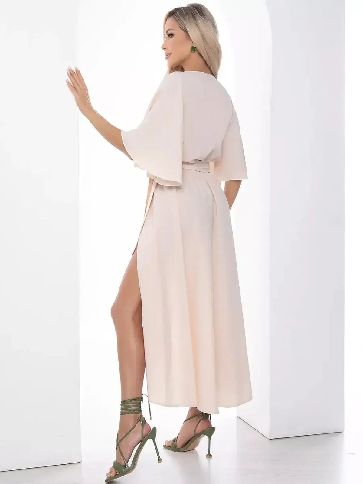 Back view of the Serenity Midi Dress featuring flared sleeves and a high side slit, perfect for weddings and formal events.