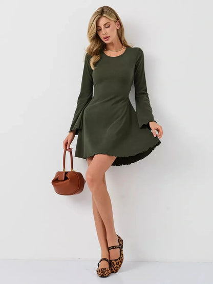Model wearing an olive green mini dress with flared bell sleeves, perfect for summer and casual occasions.