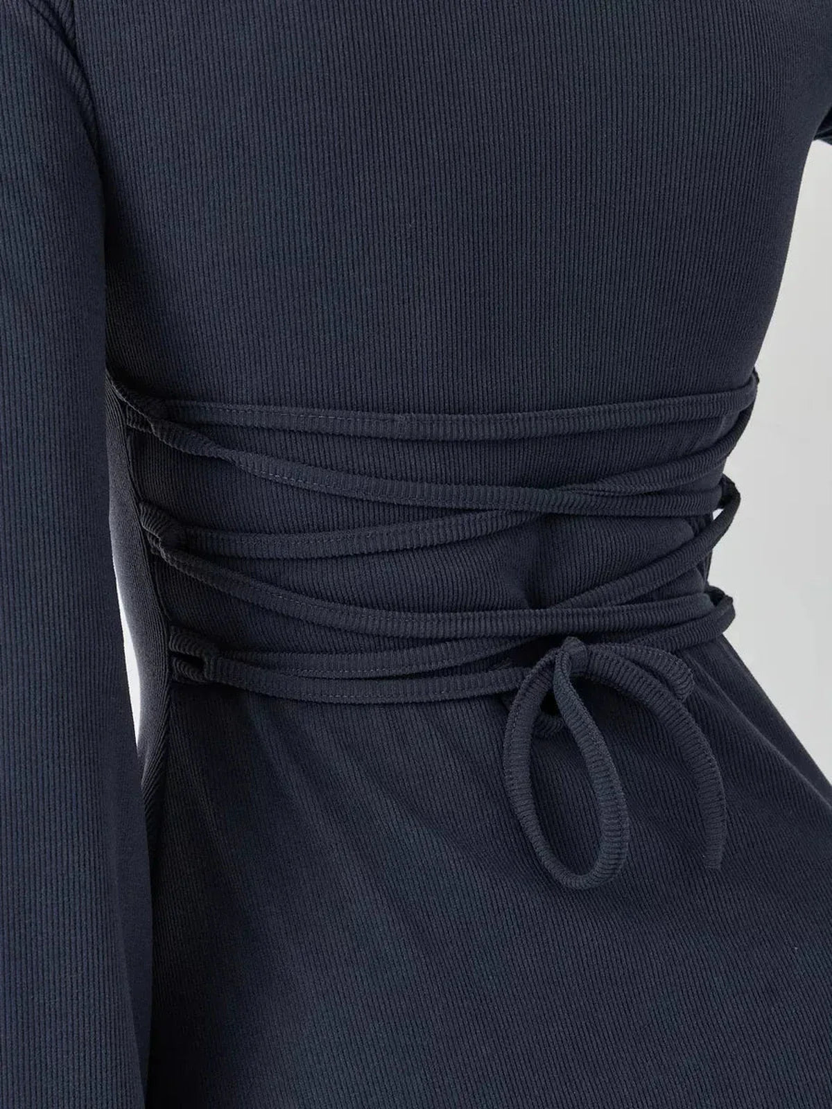Close-up detail of the lace-up back tie on the Graphite Grace ribbed mini dress, showcasing its elegant design.