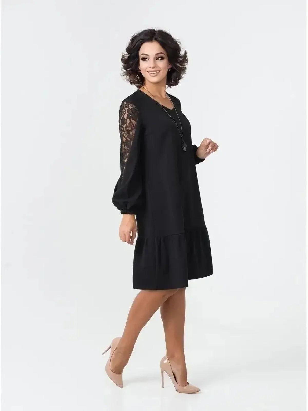 Stylish black dress featuring sheer lace sleeves, ideal for weddings, parties, and formal events.