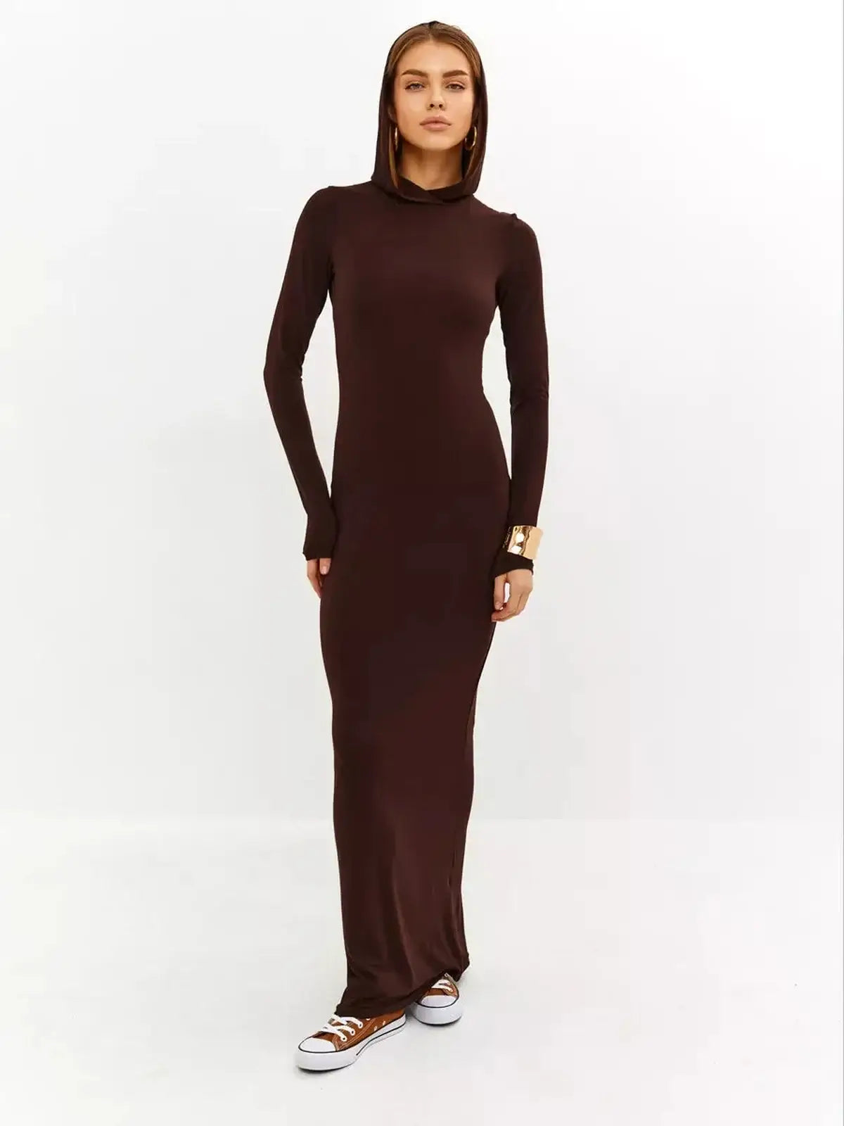 Model showcasing the Sculpt Maxi Dress in rich chocolate, featuring a sleek silhouette and hooded detail for stylish comfort.
