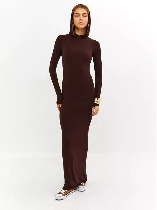 Model showcasing the Sculpt Maxi Dress in rich chocolate, featuring a sleek silhouette and hooded detail for stylish comfort.